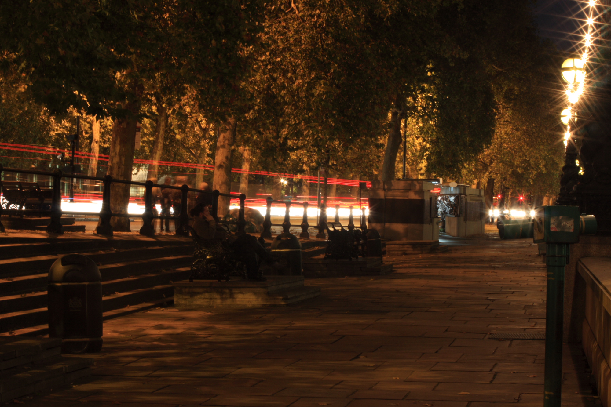Traffic trails on Victoria Embankment at night.