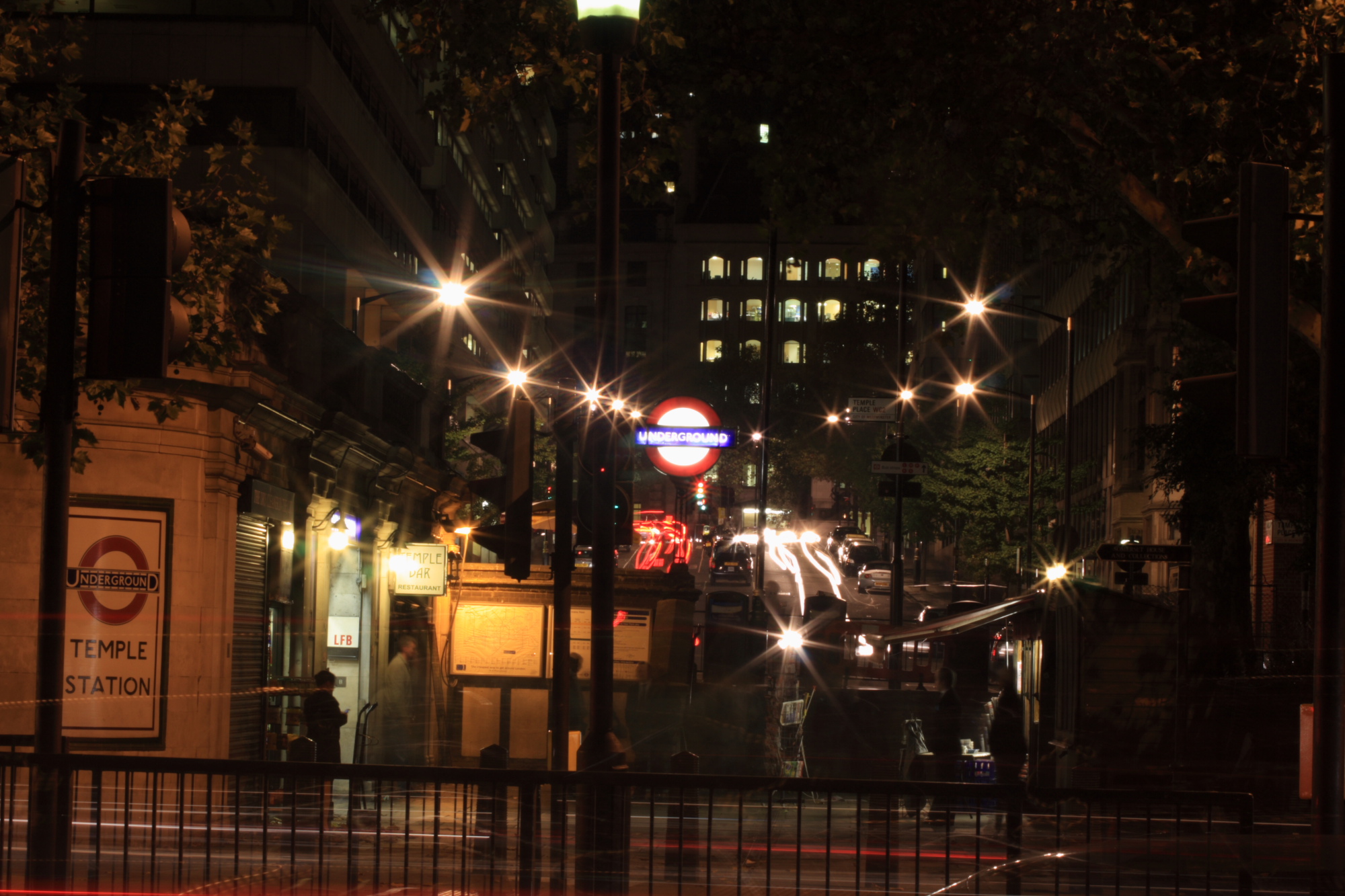 Temple underground station and traffic trails at night.