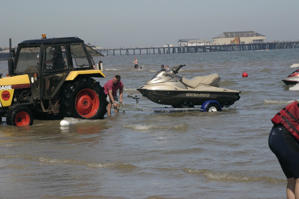 Jet ski being prepared for use with Clacton-on-Sea pier in the background.